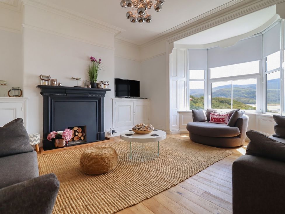 A living room with a fireplace and television at 5 Porkington Terrace in Barmouth