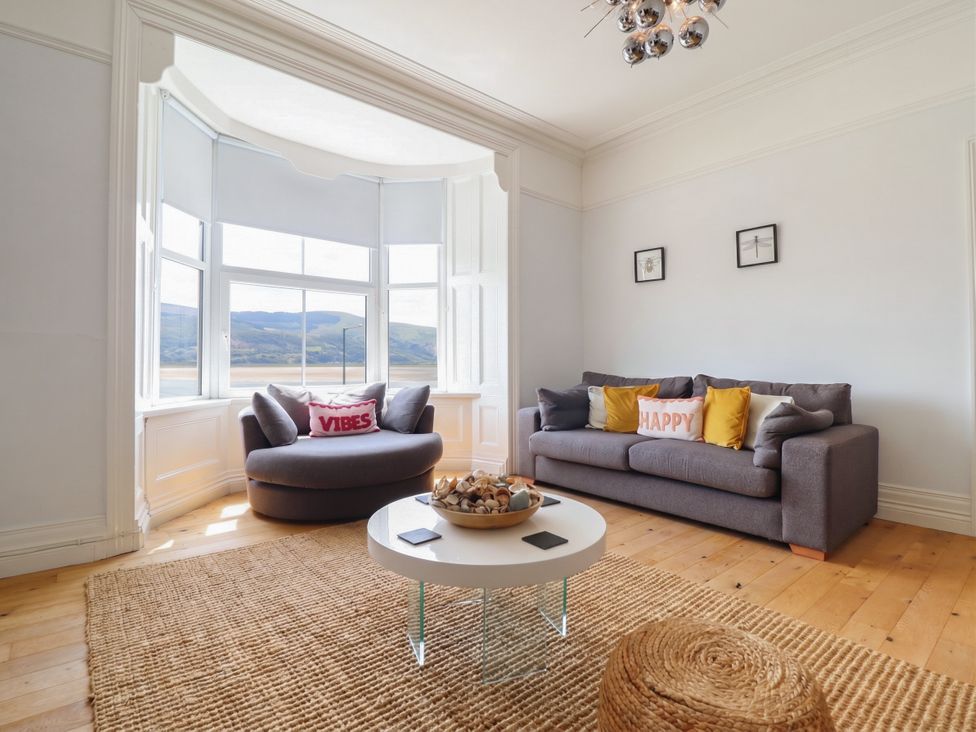 A living room with a sofa and coffee table at 5 Porkington Terrace in Barmouth