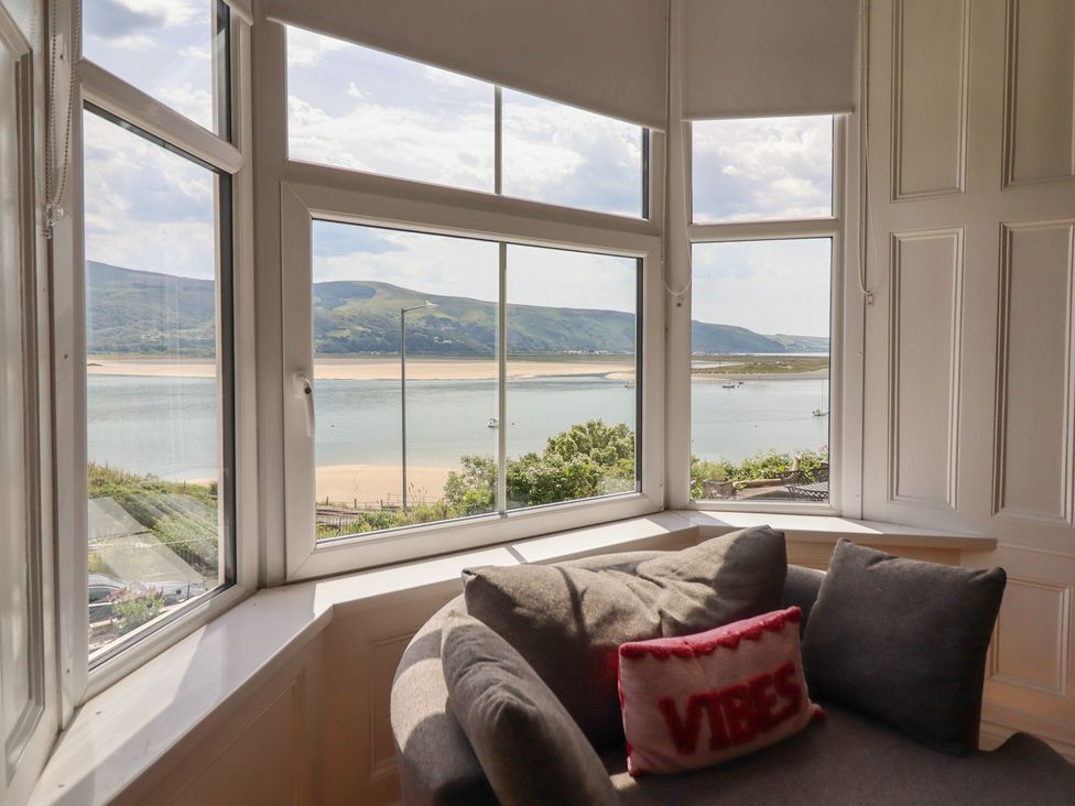 A living room with a view of the seaside and mountains at 5 Porkington Terrace in Barmouth