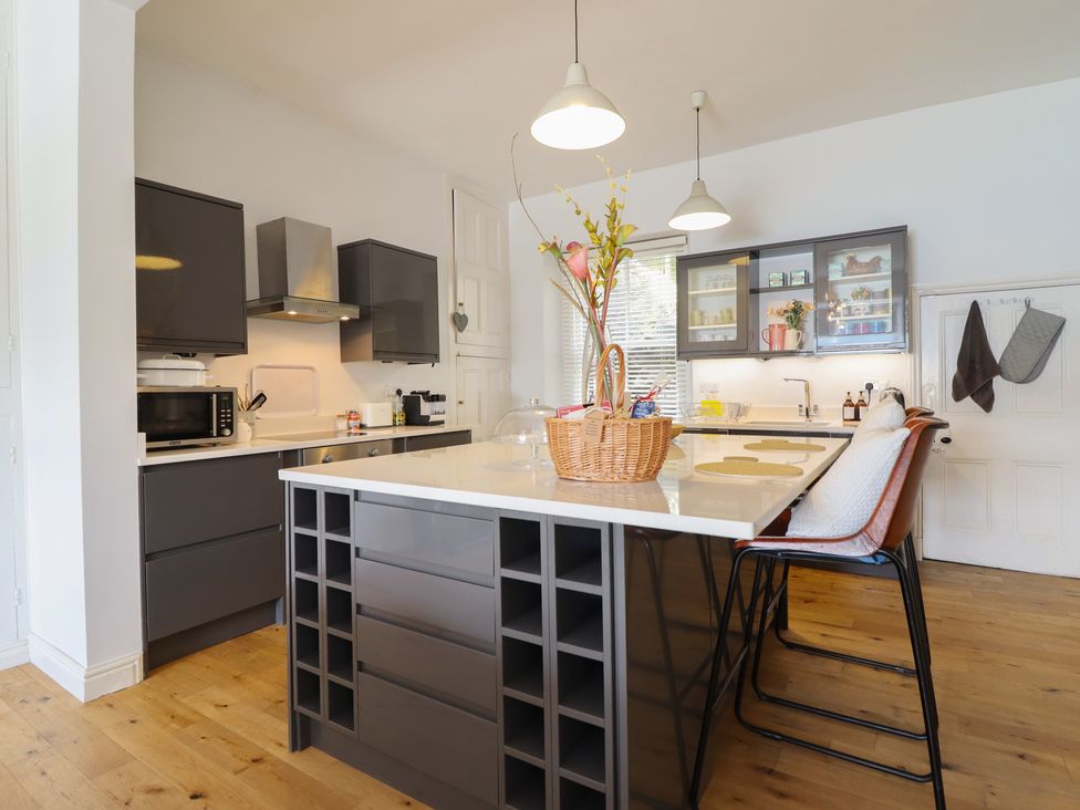 A kitchen with cabinets and a central island at 5 Porkington Terrace Barmouth