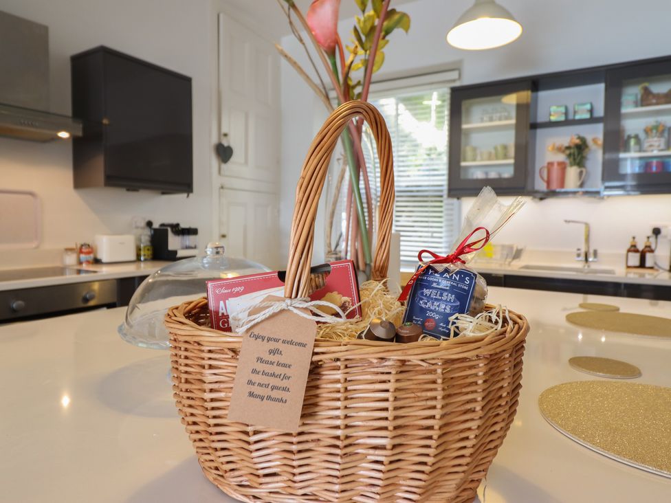 A basket with chocolates and Welsh cakes in a kitchen at 5 Porkington Terrace Barmouth