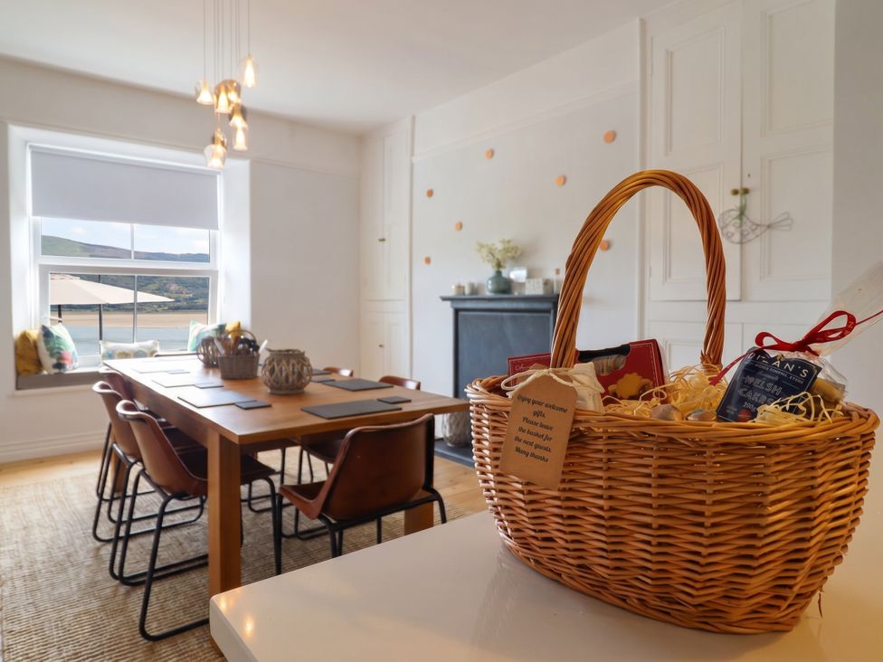 A dining room with a table and chairs at 5 Porkington Terrace in Barmouth