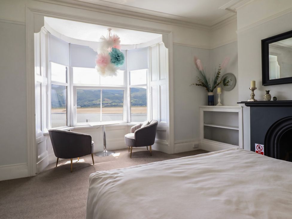A bedroom with a view of a river at 5 Porkington Terrace Barmouth