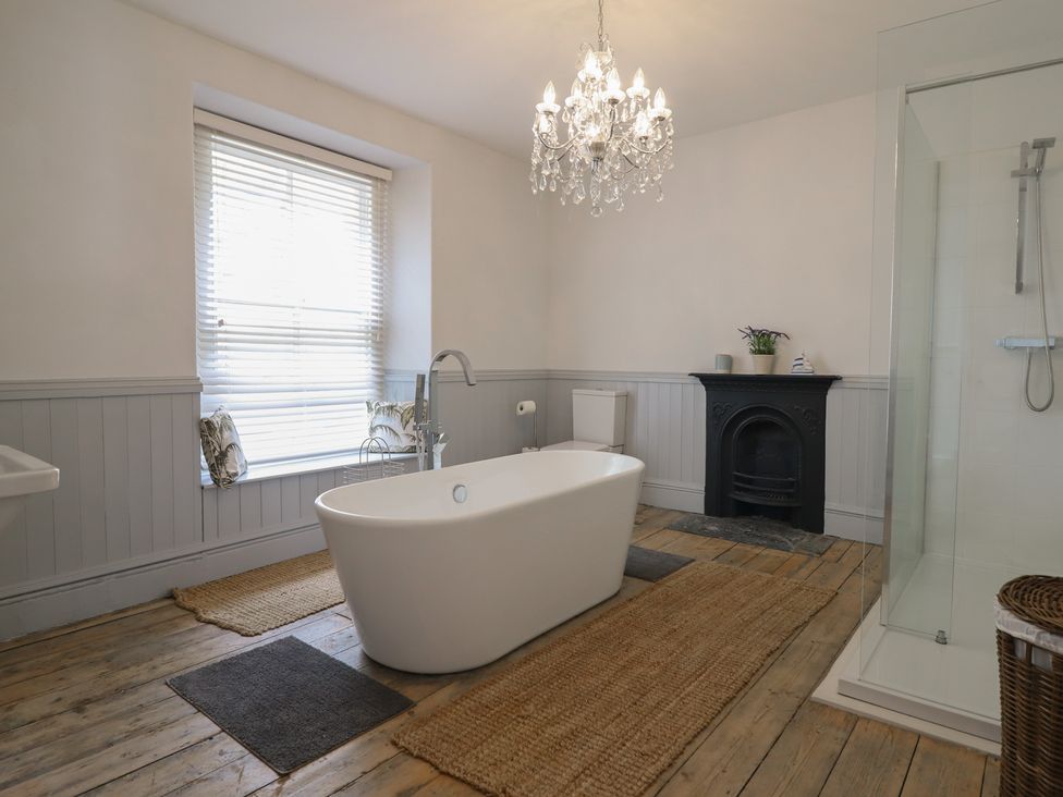 A bathroom with a bathtub and shower at 5 Porkington Terrace in Barmouth