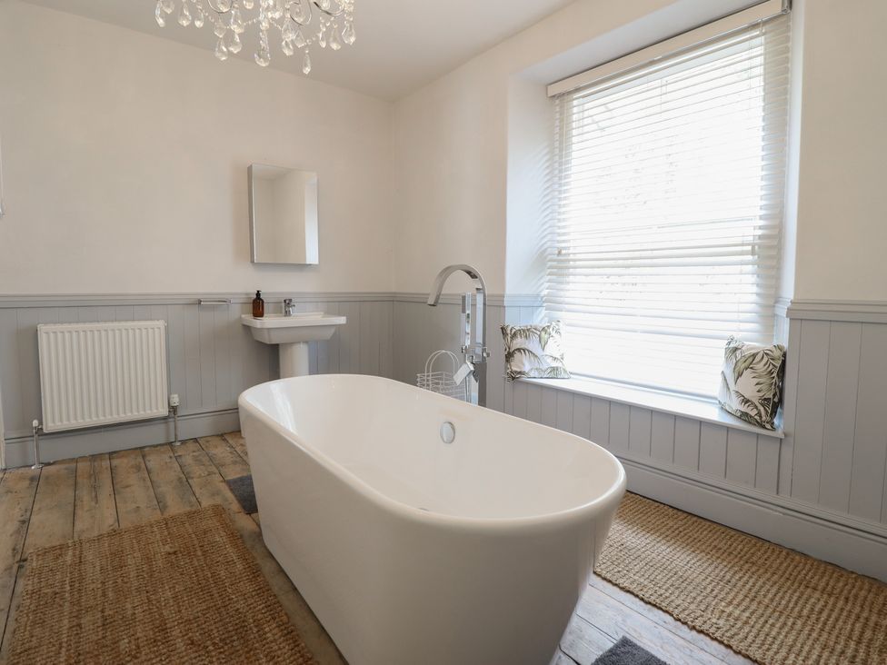 A bathroom with a bathtub and sink at 5 Porkington Terrace in Barmouth