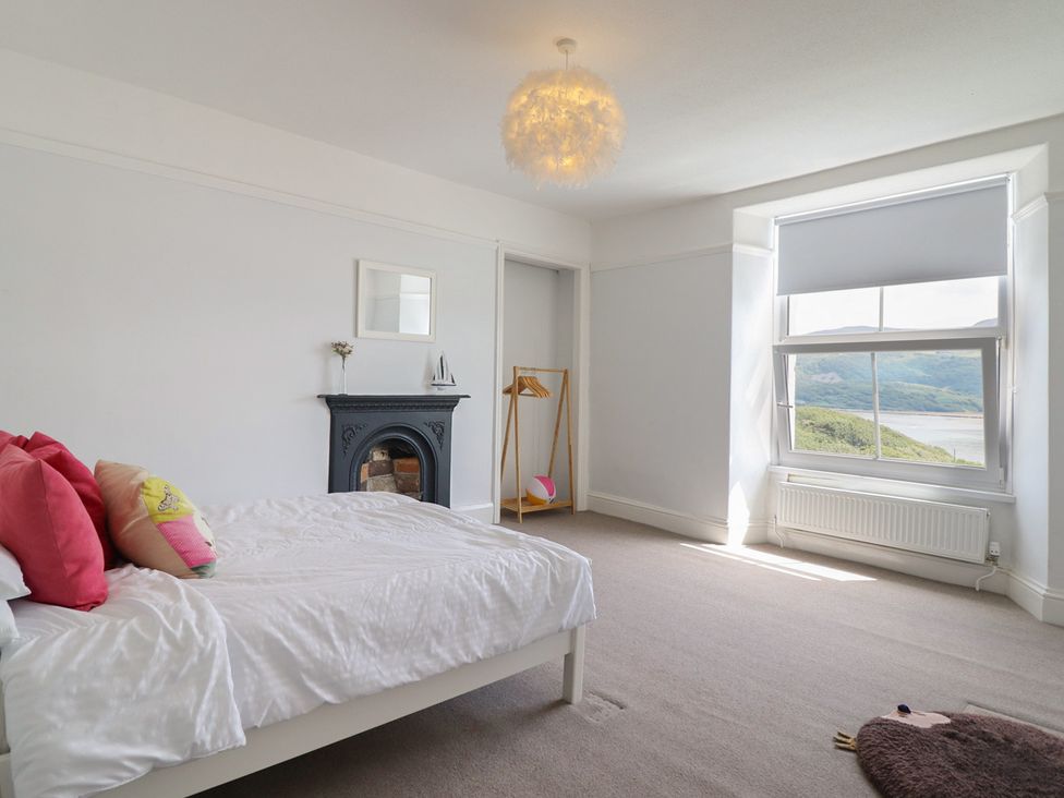 A bedroom with a bed and window at 5 Porkington Terrace in Barmouth
