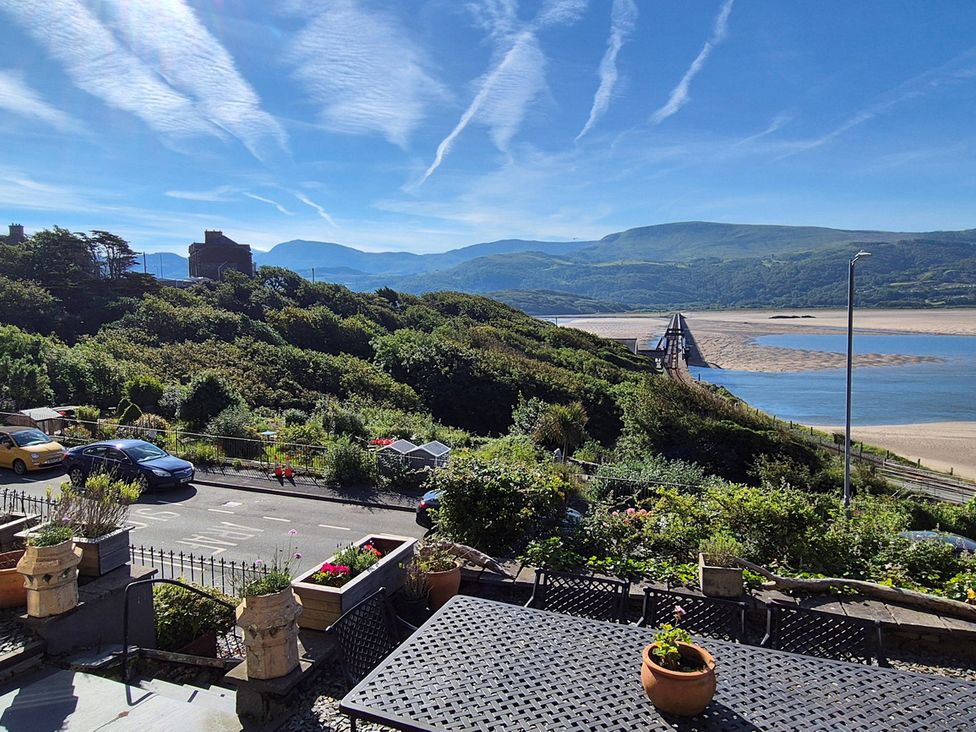 A view of a river and bridge with mountains in the background at 5 Porkington Terrace Barmouth