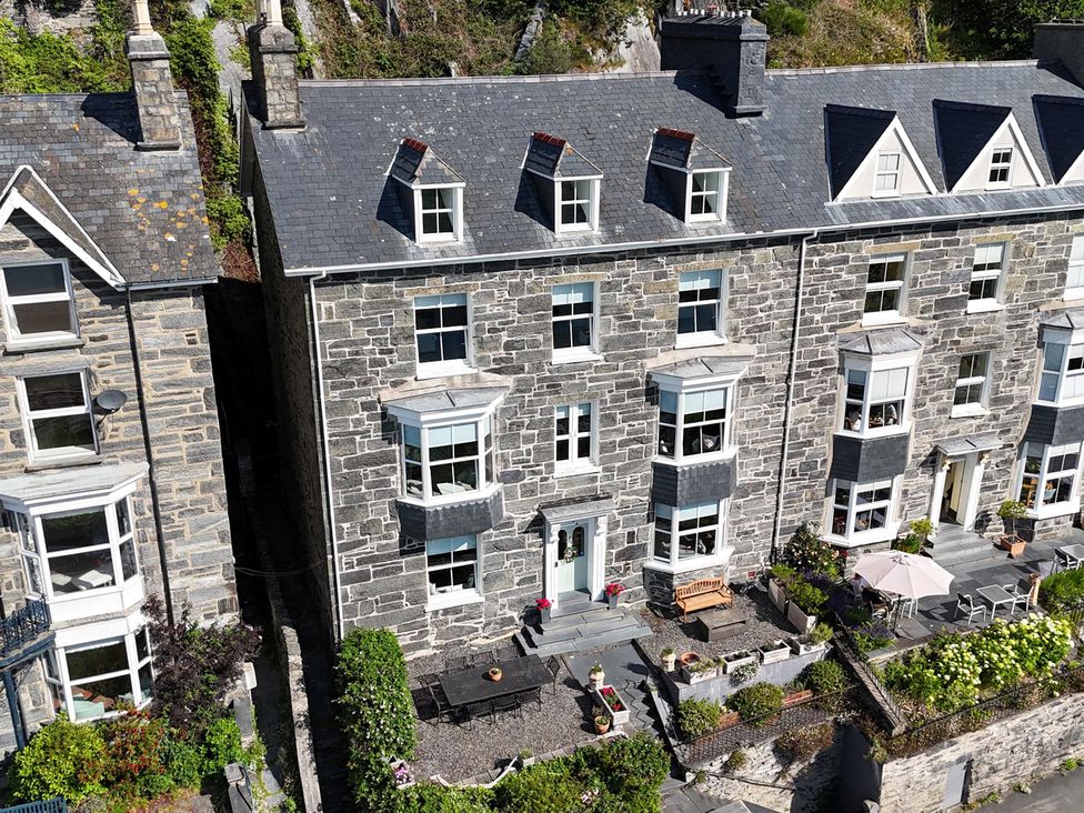 A stone house with patio furniture and garden at 5 Porkington Terrace in Barmouth