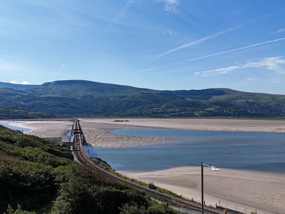 A view of a bridge over water with mountains in the background at 5 Porkington Terrace in Barmouth