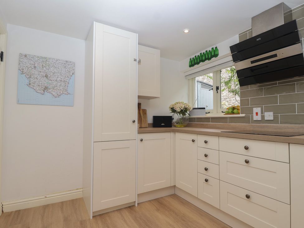 A kitchen with cabinets and a worktop at Wrens Nest in Slapton