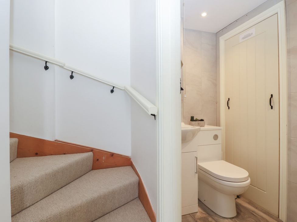A bathroom with a sink and toilet at Wrens Nest in Slapton