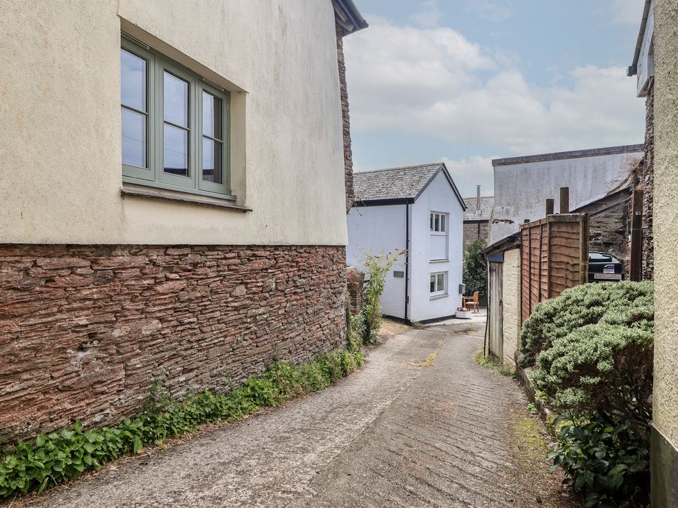 A pathway between buildings at Wrens Nest in Slapton