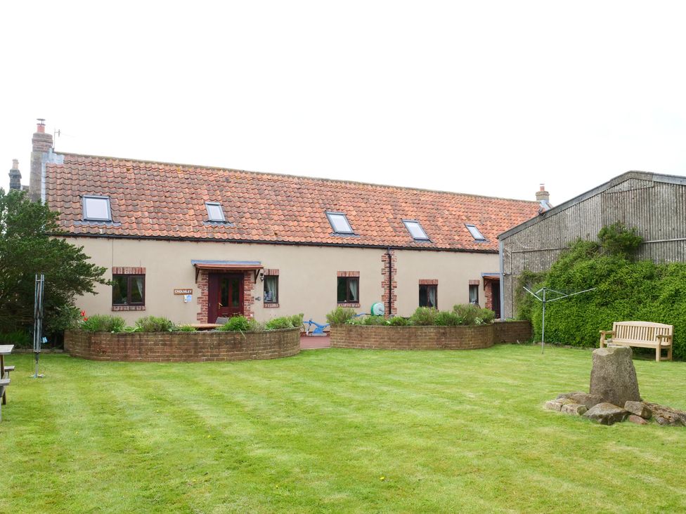 A house with a garden and bench at Scoresby Cottage @ Summerfield Farm in Hawsker