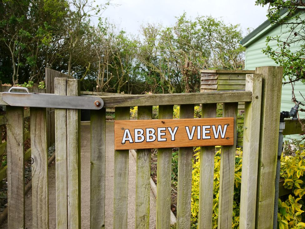 A gate with the sign 'ABBey VIEW' at Abbey View @ Summerfield Farm in Hawsker