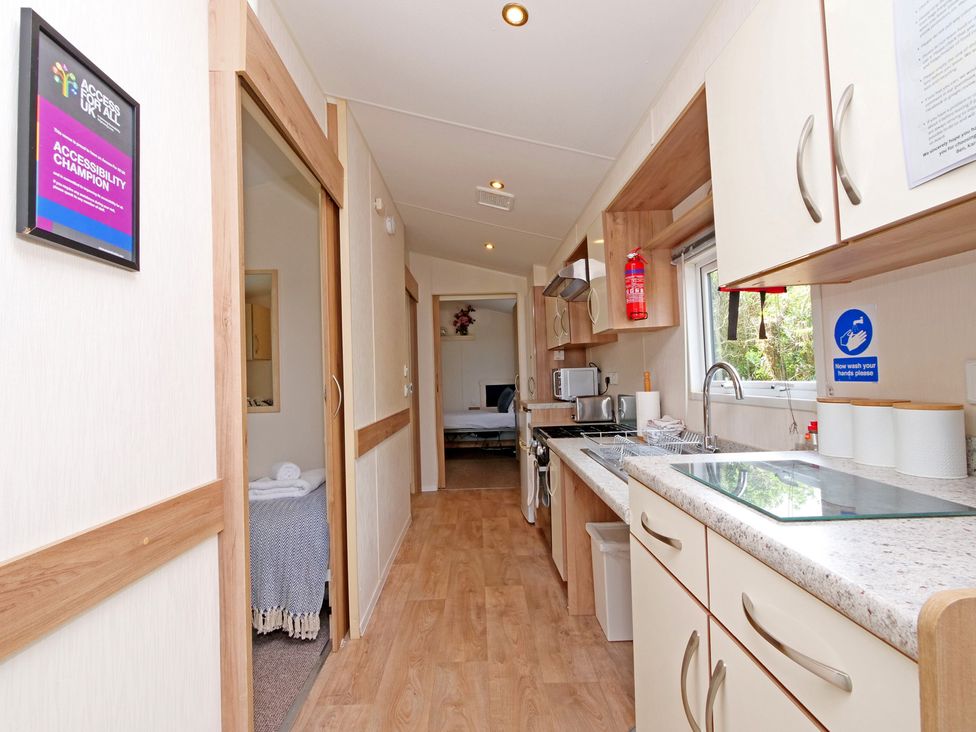 A kitchen with a sink and stove at Abbey View @ Summerfield Farm Hawsker