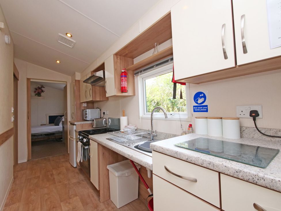 A kitchen with cabinets, sink, and stove at Abbey View @ Summerfield Farm, Hawsker