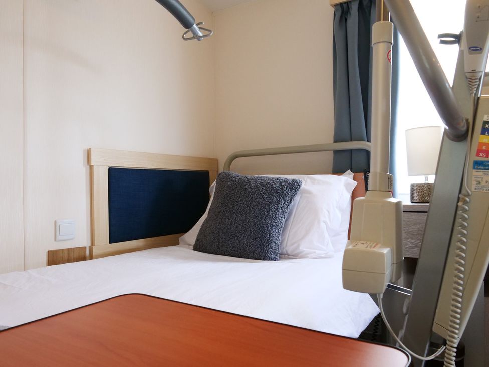 A hospital room with a bed and a bedside table at Abbey View @ Summerfield Farm in Hawsker