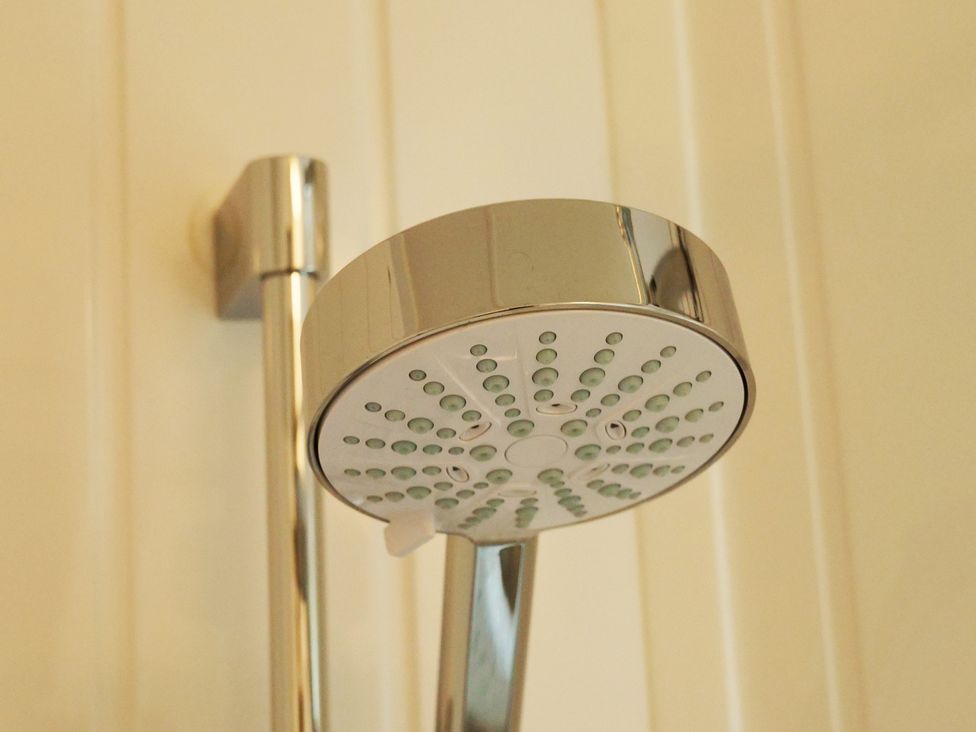 A shower head mounted on the wall at Abbey View @ Summerfield Farm in Hawsker