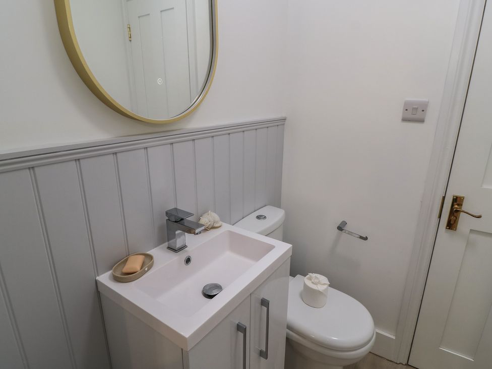 A bathroom with a sink and toilet at Still Waters in Swanage