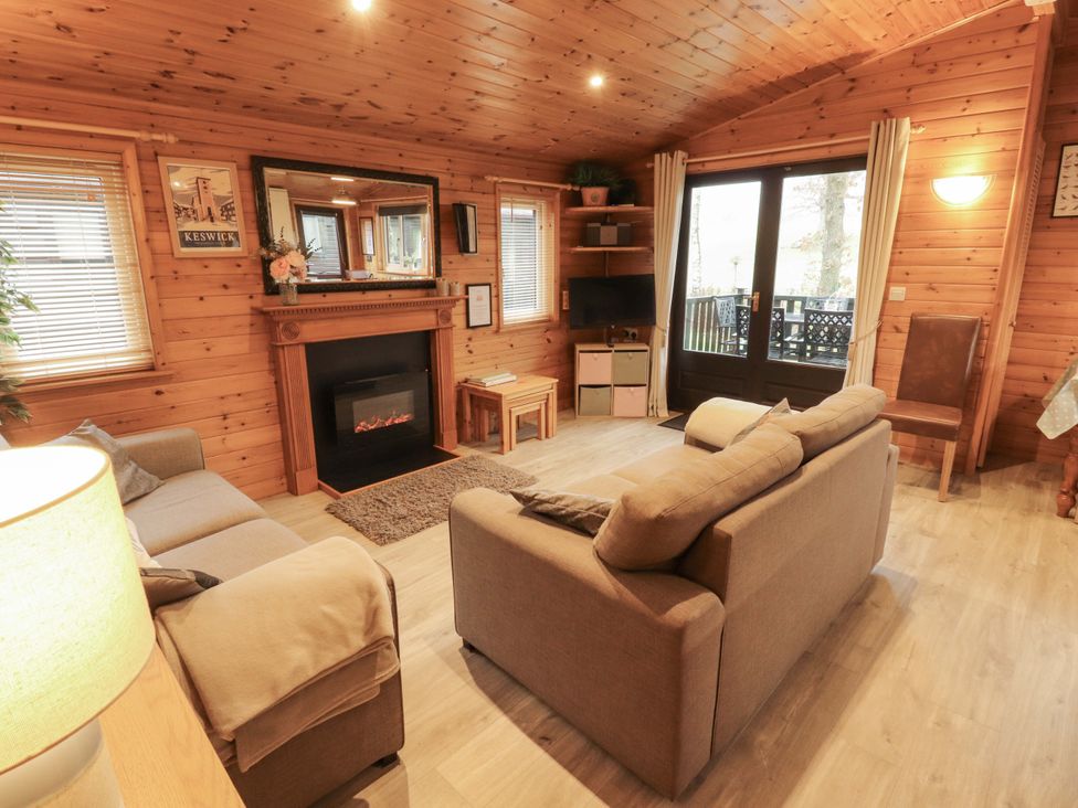 A living room with a sofa and fireplace at The Fold near Number 28, Burnside Park near Keswick