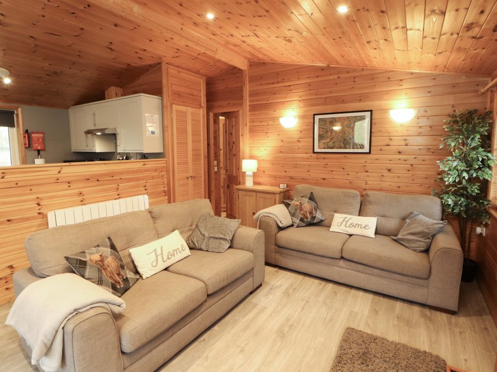 A living room with sofas and a kitchen unit at The Fold near Keswick