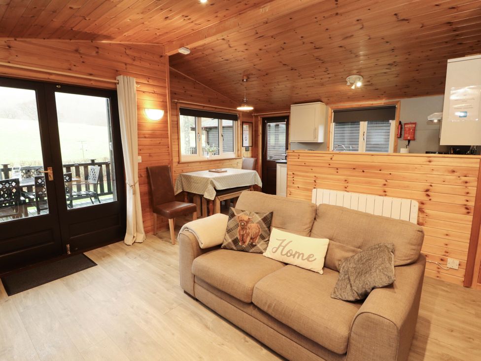 A living room with a sofa and dining area at The Fold near Number 28, Burnside Park near Keswick