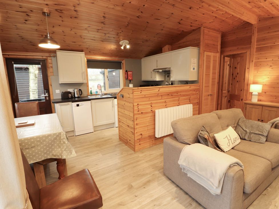 A kitchen with appliances and seating area at The Fold Number 28, Burnside Park near Keswick