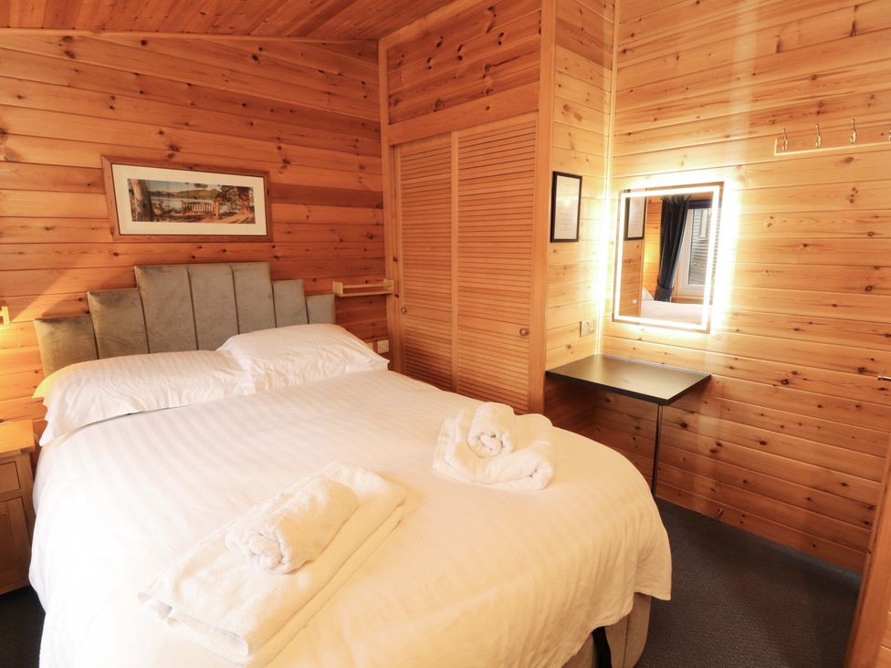 A bedroom with a bed and towels on top at The Fold, Number 28, Burnside Park near Keswick