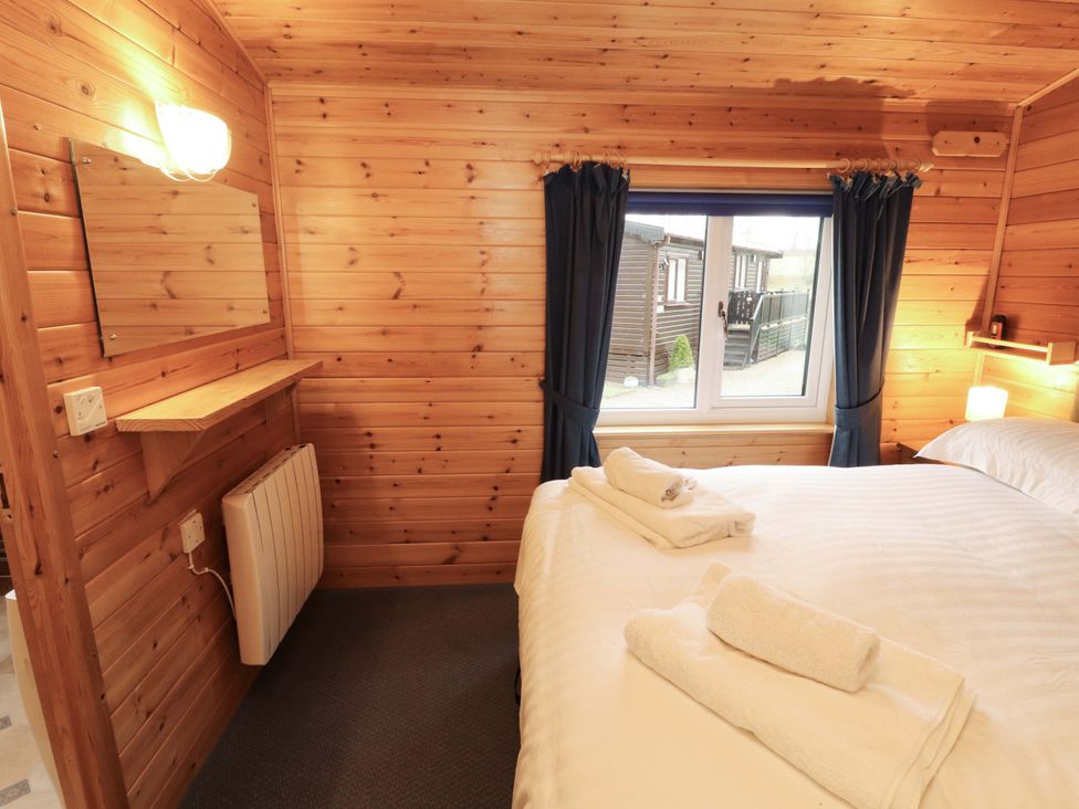 A bedroom with a bed and towels arranged at The Fold near Keswick