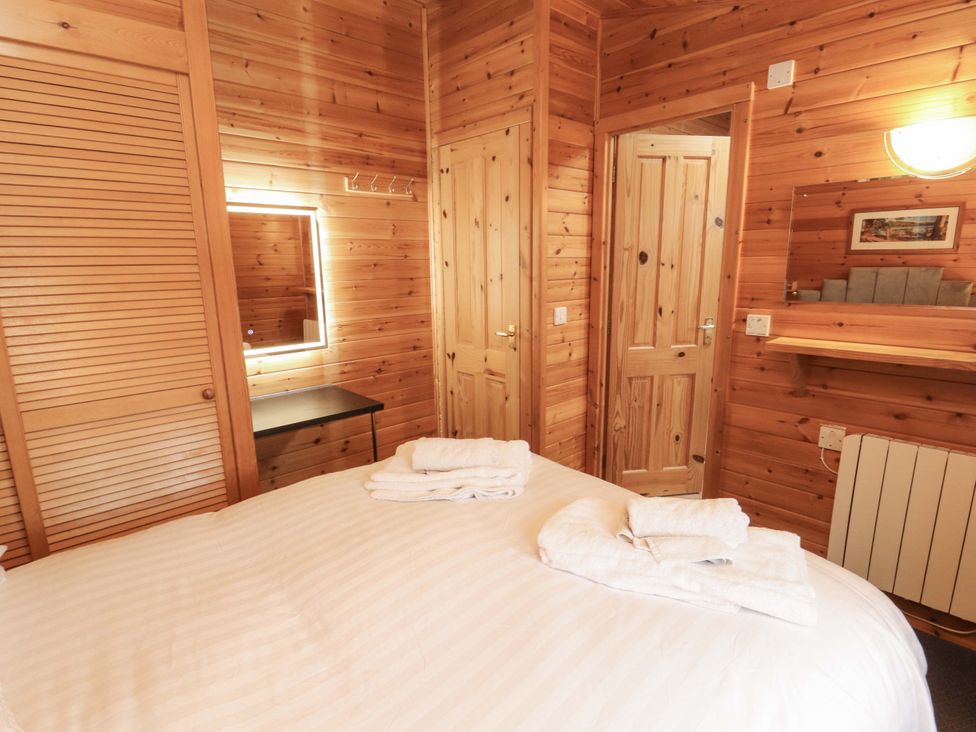 A bedroom with a bed and mirror at The Fold near Keswick