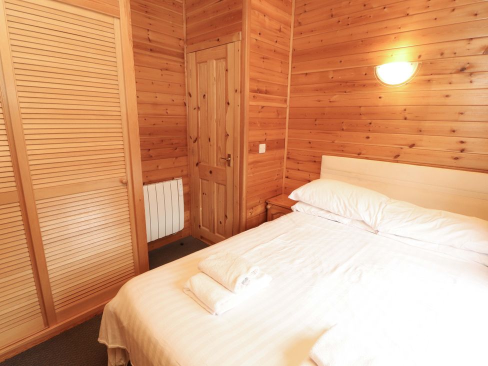 A bedroom with a bed and closet at The Fold near Number 28, Burnside Park near Keswick