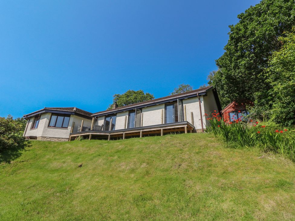 A house with a deck and windows on a hill at Allt An Dorran in Salen