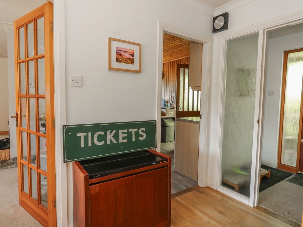 A hallway with a ticket sign and doorways at Allt An Dorran in Salen