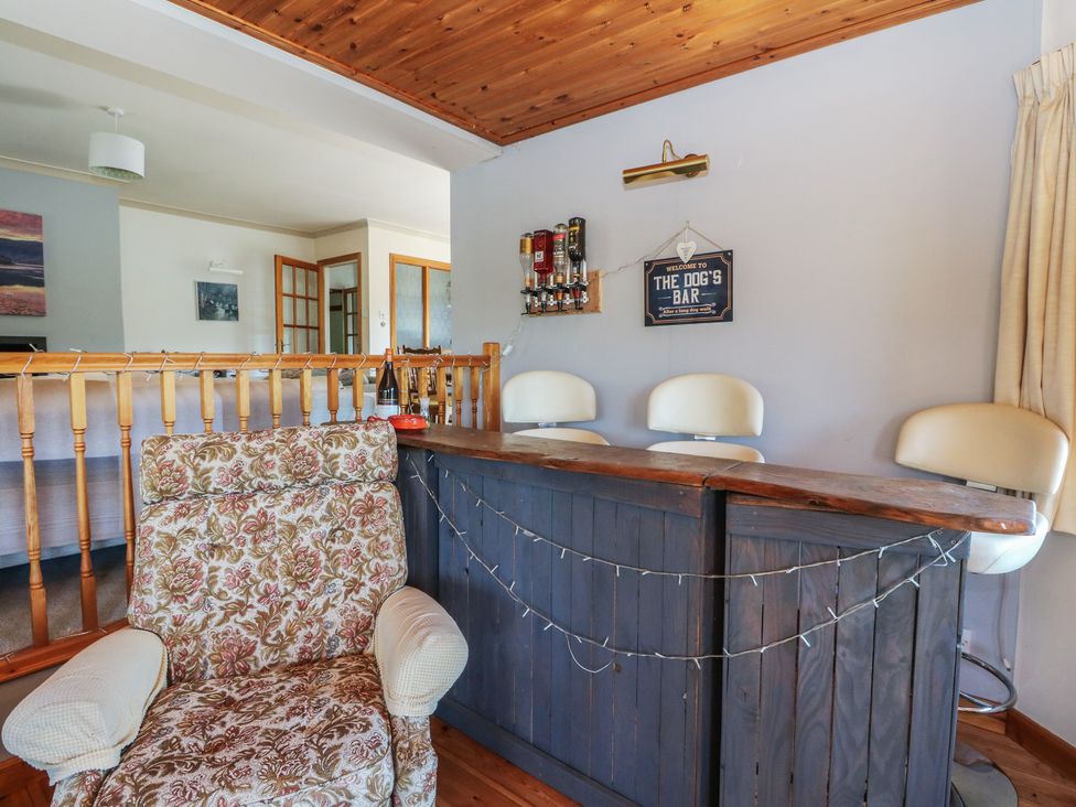 A home bar area with a chair and bar stools at Allt An Dorran in Salen