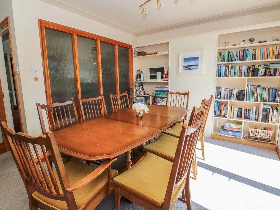 A dining room with a wooden table and chairs at Allt An Dorran in Salen