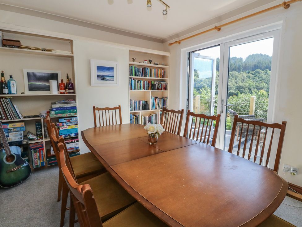 A dining room with a table and chairs at Allt An Dorran in Salen