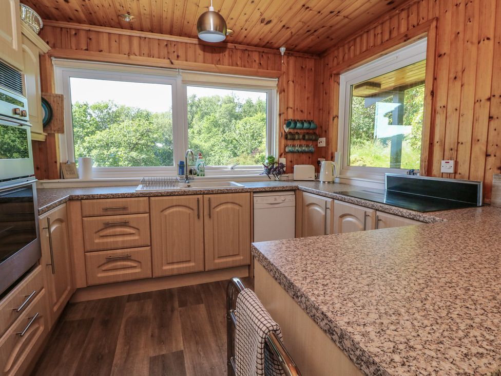 A kitchen with wooden walls and a countertop at Allt An Dorran in Salen