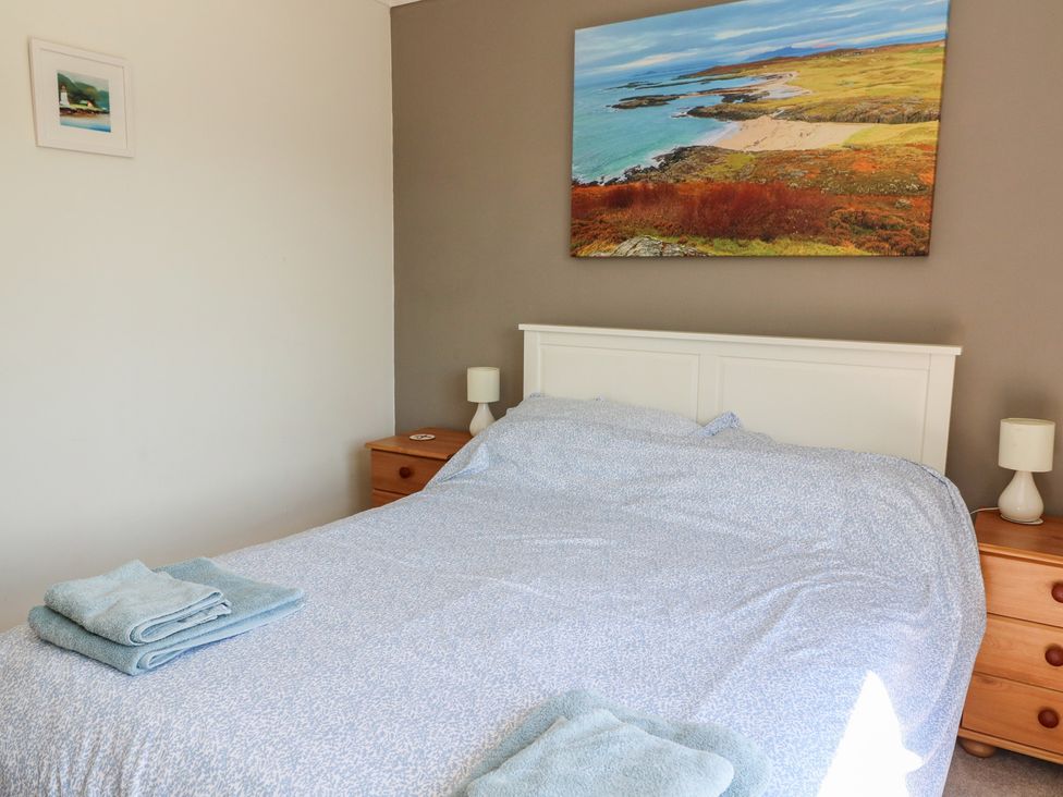 A bedroom with a bed and bedside tables at Allt An Dorran in Salen