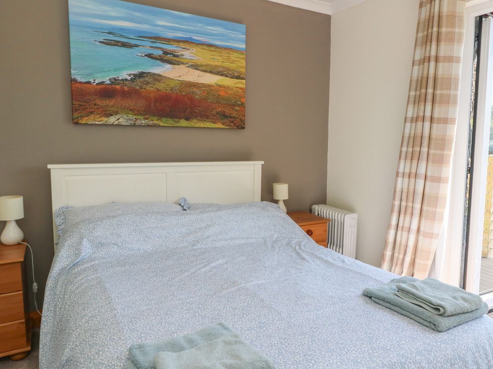 A bedroom with a bed and a landscape painting at Allt An Dorran in Salen