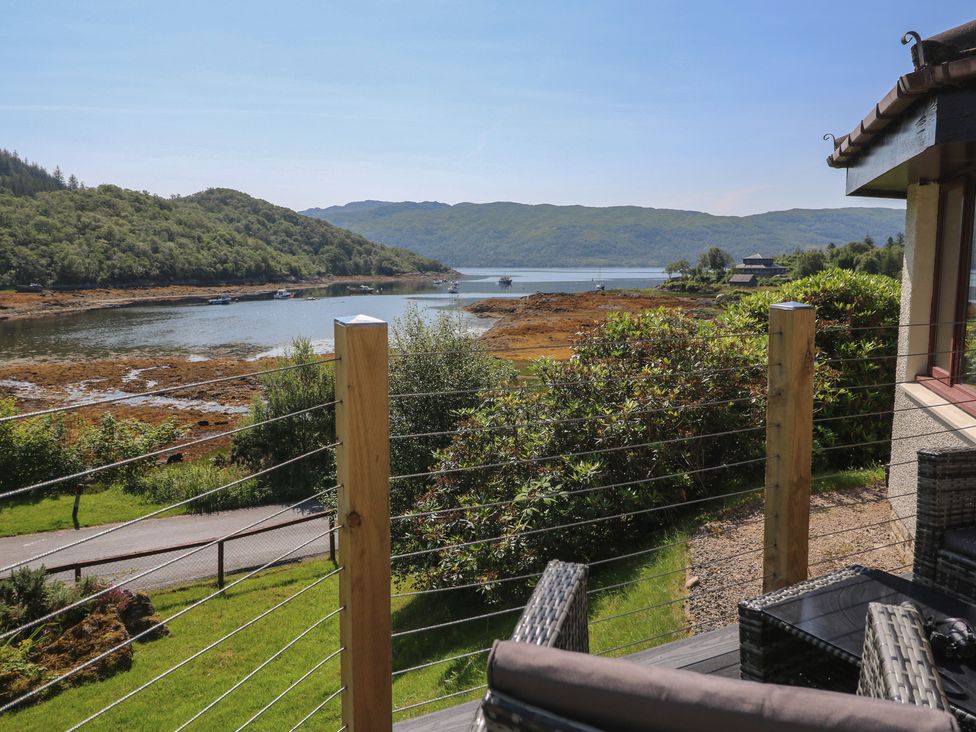 A view of water and mountains from a deck at Allt An Dorran in Salen