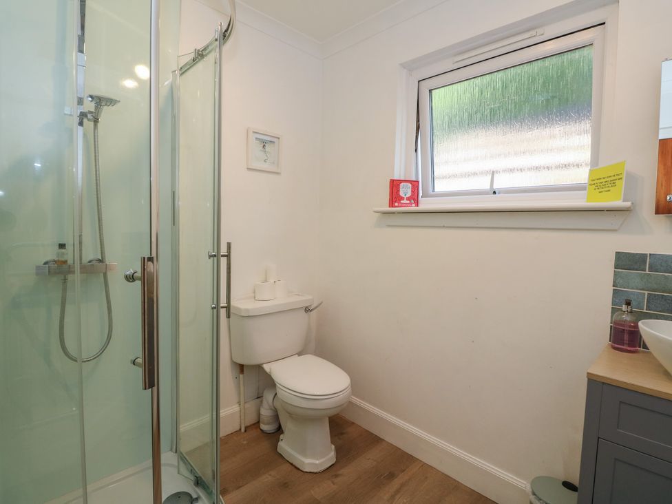 A bathroom with shower, toilet, and sink at Allt An Dorran Salen