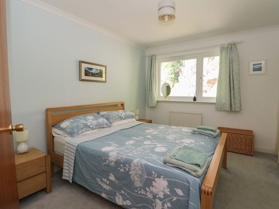 A bedroom with a bed and bedside table at Allt An Dorran in Salen
