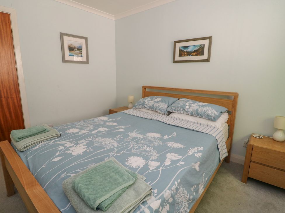 A bedroom with a bed, bedside table and lamp at Allt An Dorran, Salen
