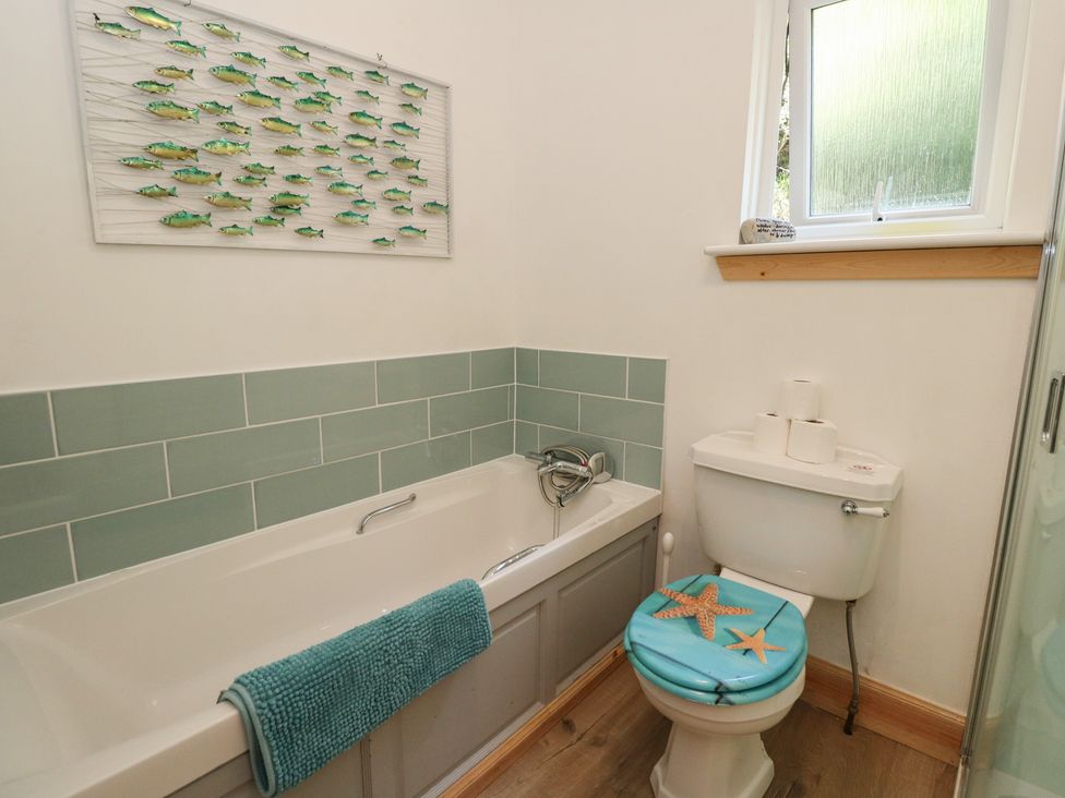 A bathroom with a bath and toilet at Allt An Dorran in Salen