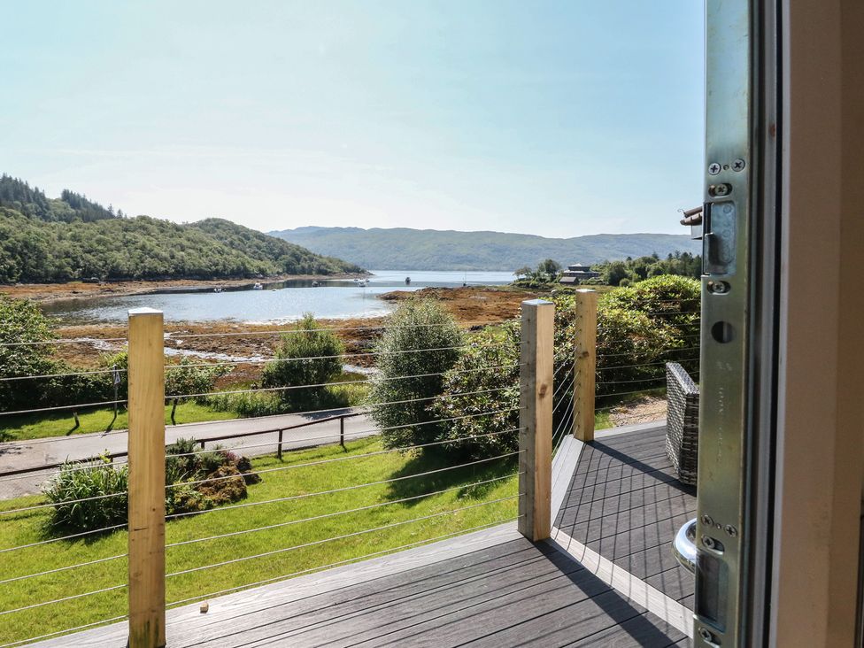A view of water and hills from a deck at Allt An Dorran in Salen