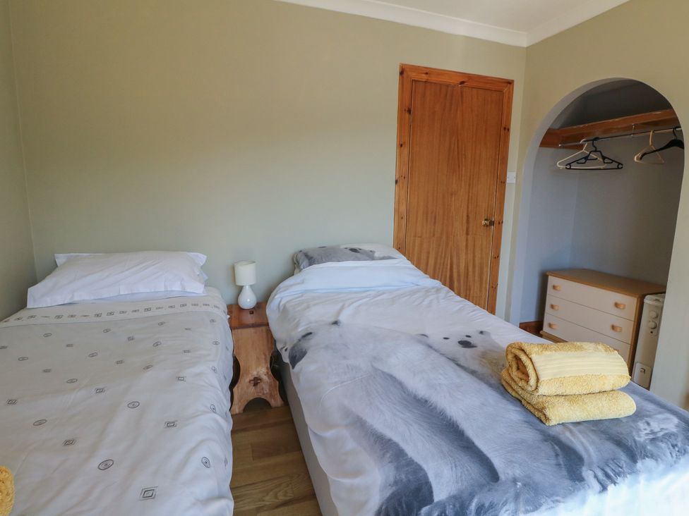 A bedroom with two beds and a nightstand at Allt An Dorran in Salen