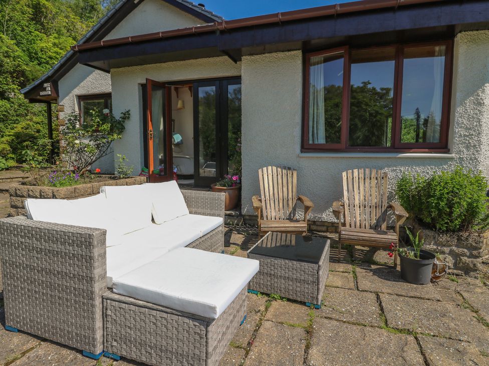An outdoor seating area with a couch, chairs, and table at Allt An Dorran in Salen