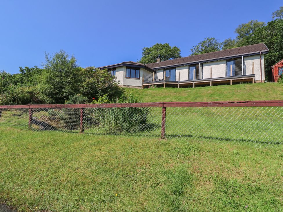 A house with a deck and fence at Allt An Dorran in Salen