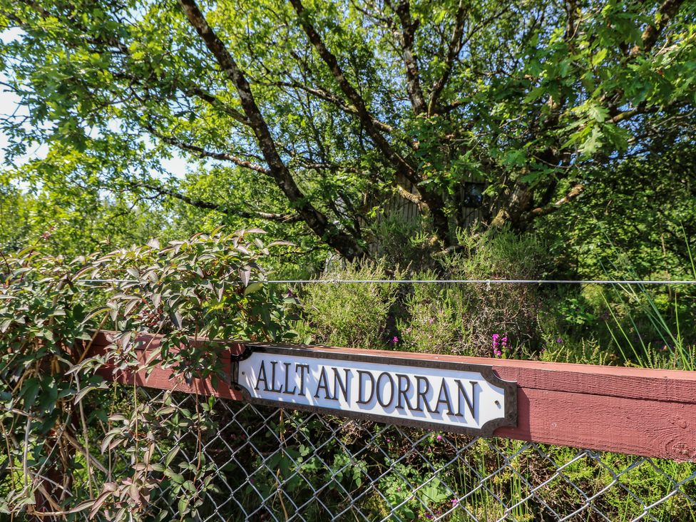 A sign on a fence with greenery at Allt An Dorran in Salen
