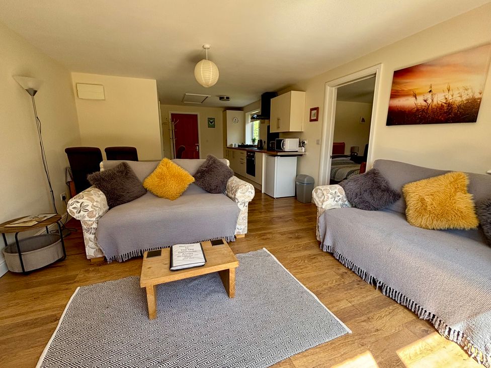 A living room with sofas and a coffee table at The Old Gate House Annexe in Alford